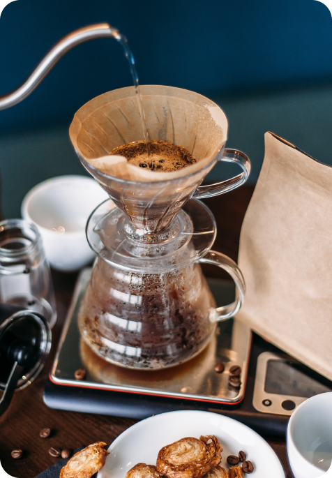 Brewing coffee with the right apparatus, with a side snack.