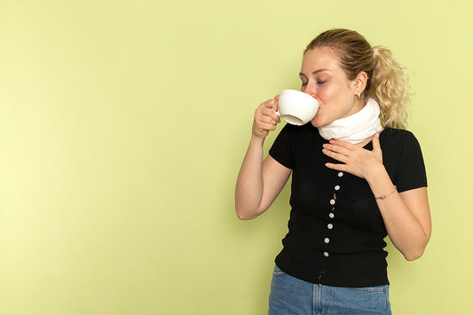 Is coffee good for sore throat? | Woman drinking coffee to treat sore throat