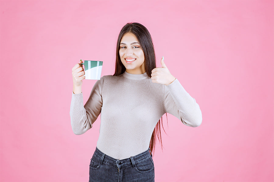 Can you drink coffee with Invisalign? | A girl holding a coffee cup